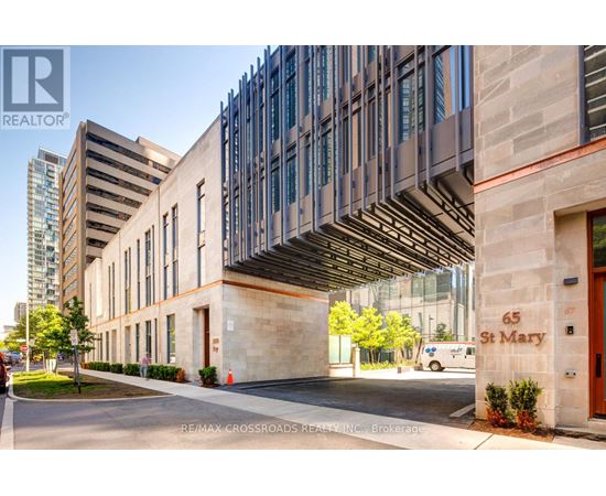 A modern building with a glass facade and a stone entrance.