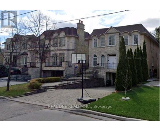 A large house with a stone facade and a white door.