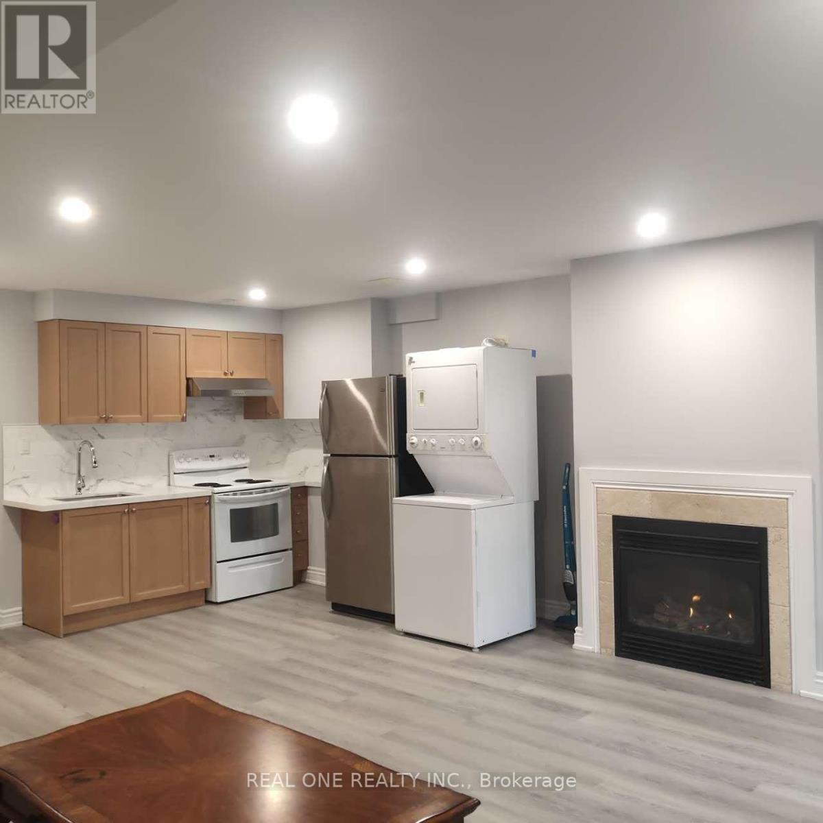 A kitchen with a refrigerator, stove, and oven.