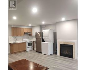 A kitchen with a refrigerator, stove, and oven.