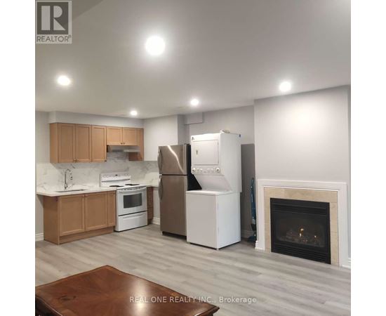 A kitchen with a refrigerator, stove, and oven.