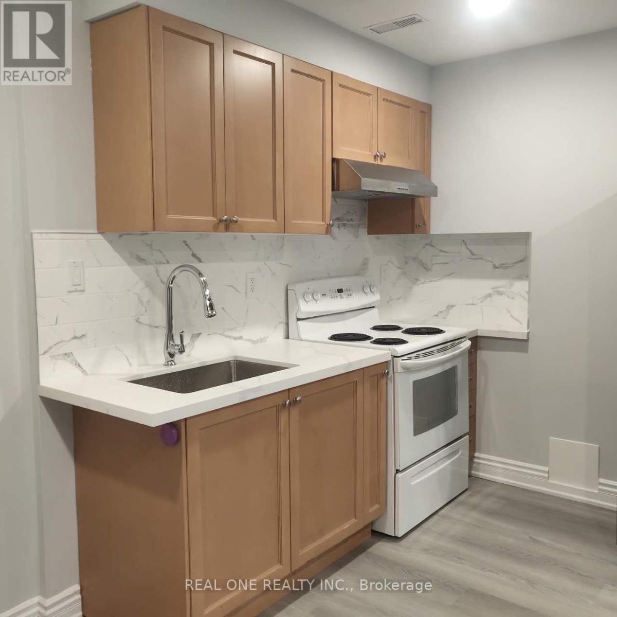 A kitchen with brown cabinets and a white stove top oven.