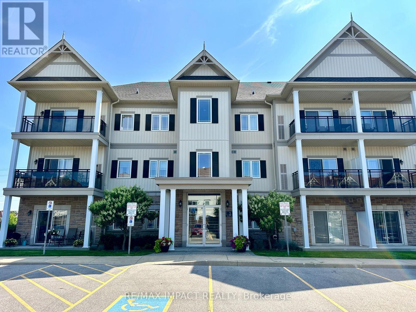 A large apartment building with a parking lot in front.