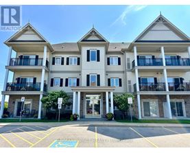 A large apartment building with a parking lot in front.