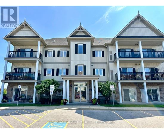 A large apartment building with a parking lot in front.