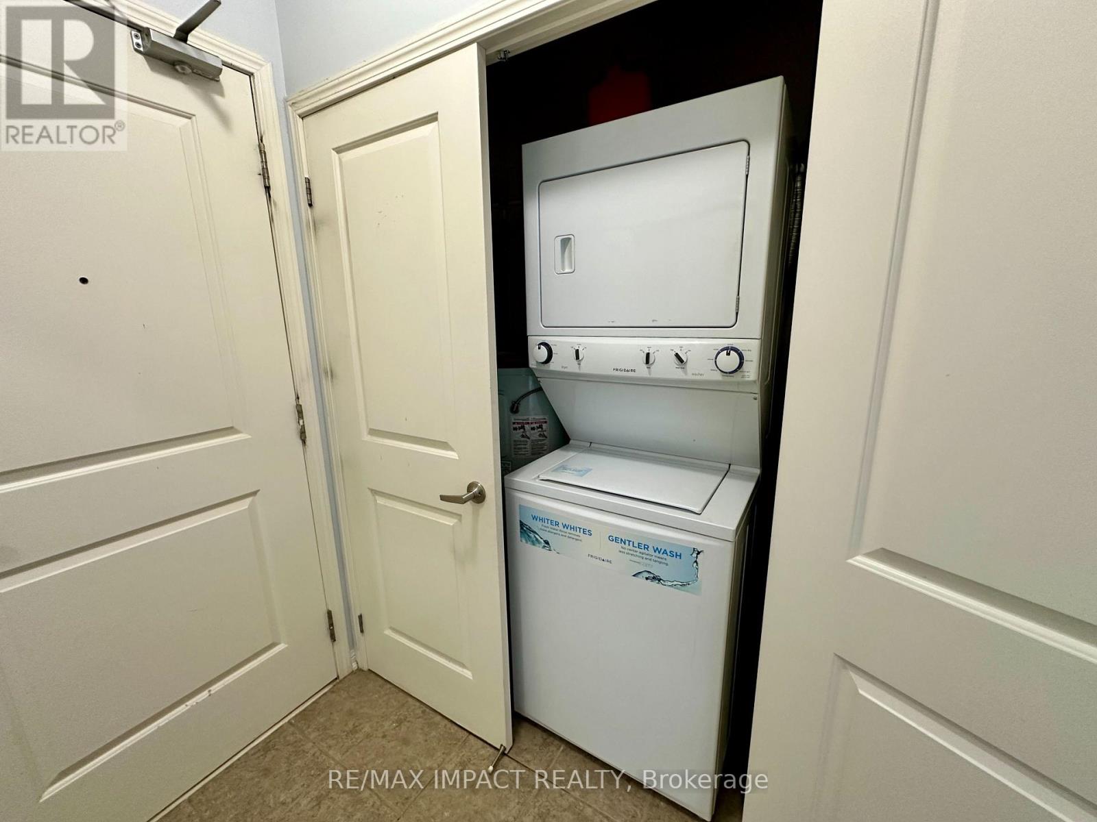 A white dishwasher is in a small kitchen.