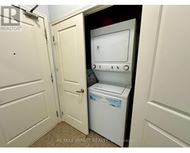 A white dishwasher is in a small kitchen.