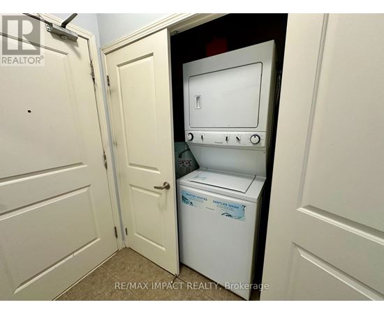 A white dishwasher is in a small kitchen.