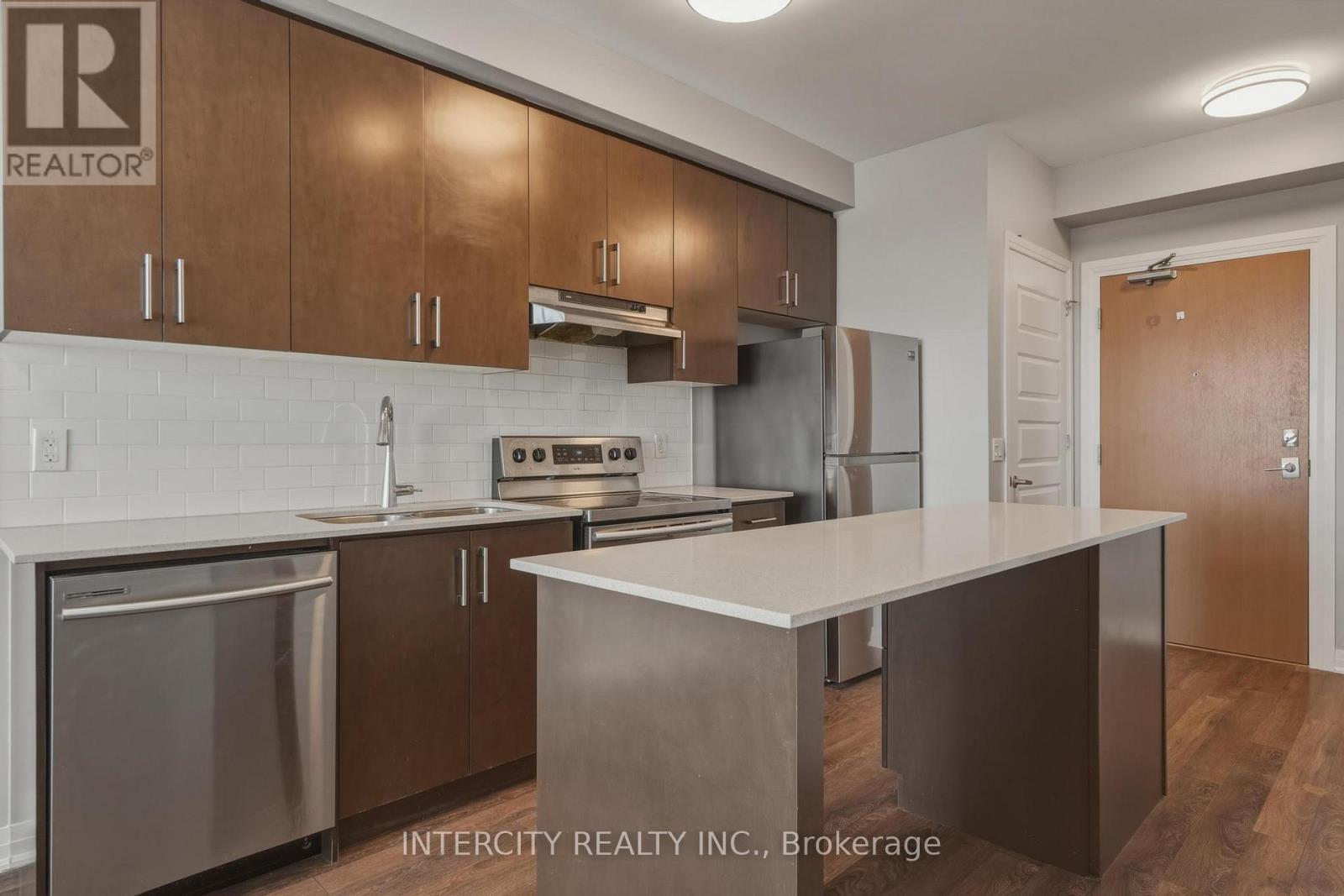 A kitchen with wooden cabinets and stainless steel appliances.