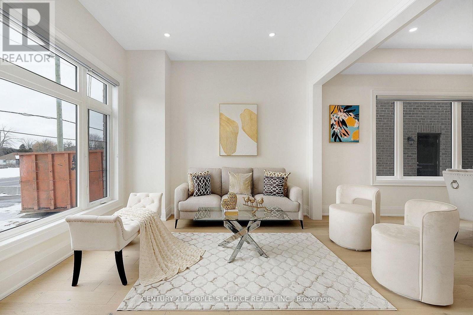 A living room with a white couch and a coffee table.