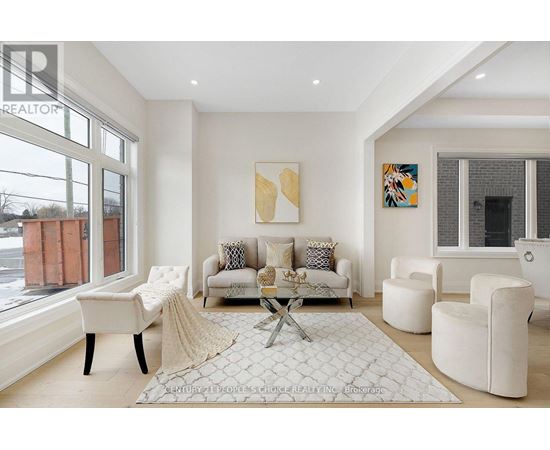 A living room with a white couch and a coffee table.