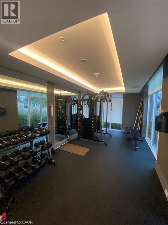 A well-lit home gym with a variety of exercise equipment.