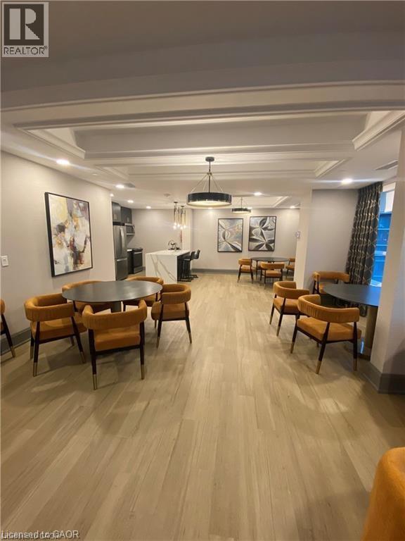 A dining room with a table and chairs.