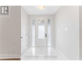 A hallway with a door and a light on the ceiling.