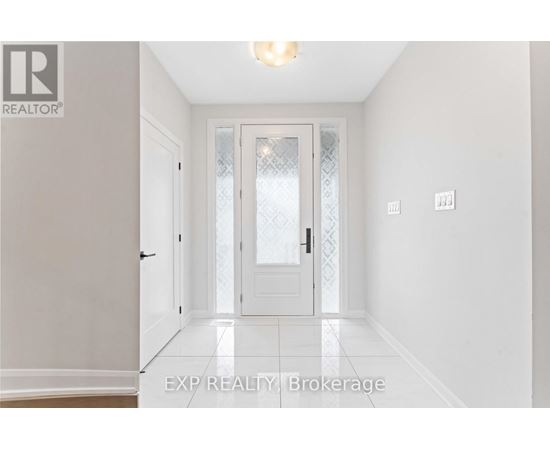 A hallway with a door and a light on the ceiling.