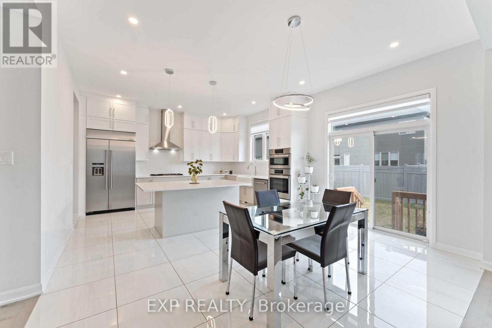 A modern kitchen with a glass table and chairs.