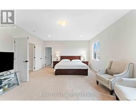 A bedroom with a bed, a chair, and a television.