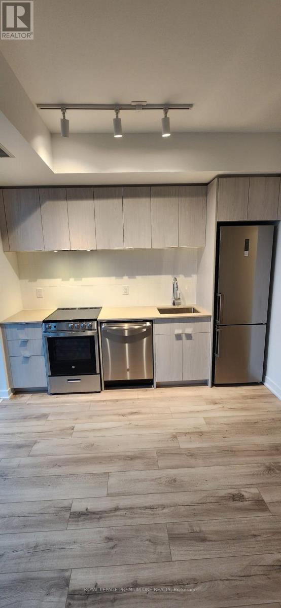 A kitchen with a stove, oven, and refrigerator.