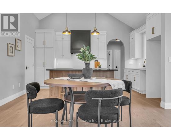 A kitchen with a table and chairs in the foreground.