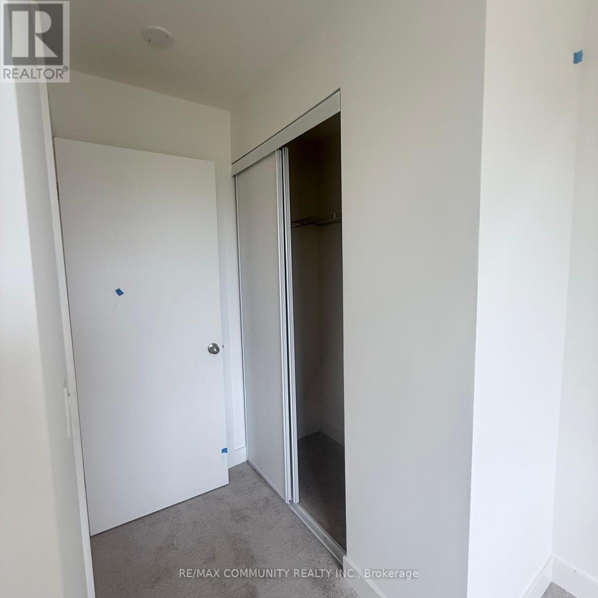A white door is in a white room.