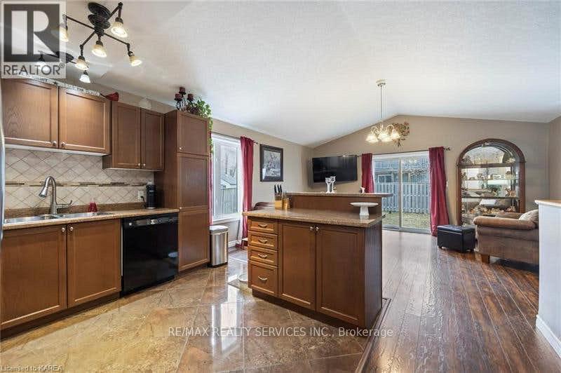 A kitchen with wooden cabinets and a large island.