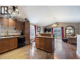 A kitchen with wooden cabinets and a large island.