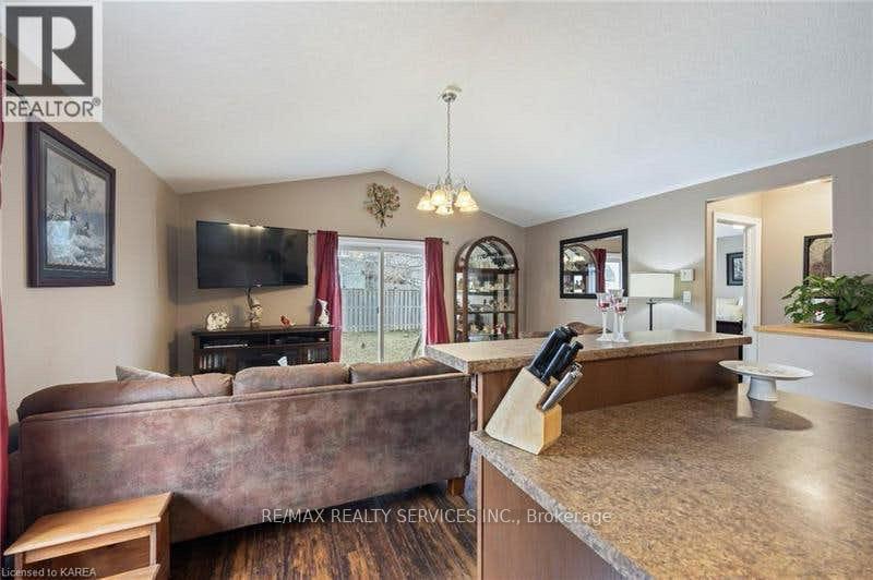 A living room with a brown couch and a television.