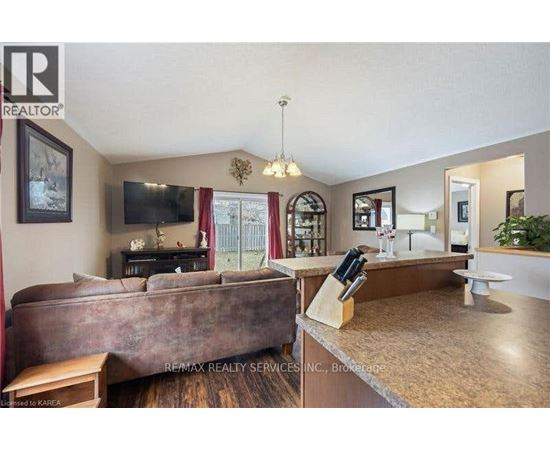 A living room with a brown couch and a television.