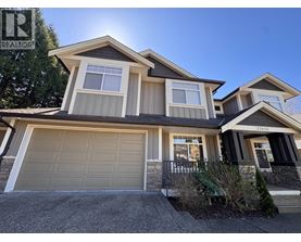 A house with a garage is for sale.