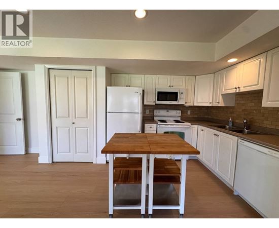 A kitchen with a table and chairs in the middle of the room.