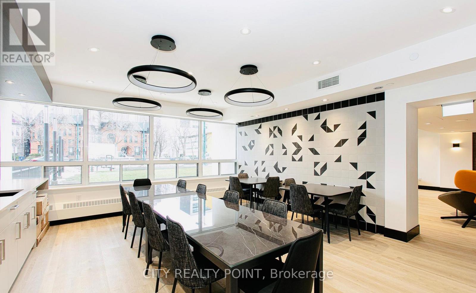 A modern dining room with a large table and chairs.