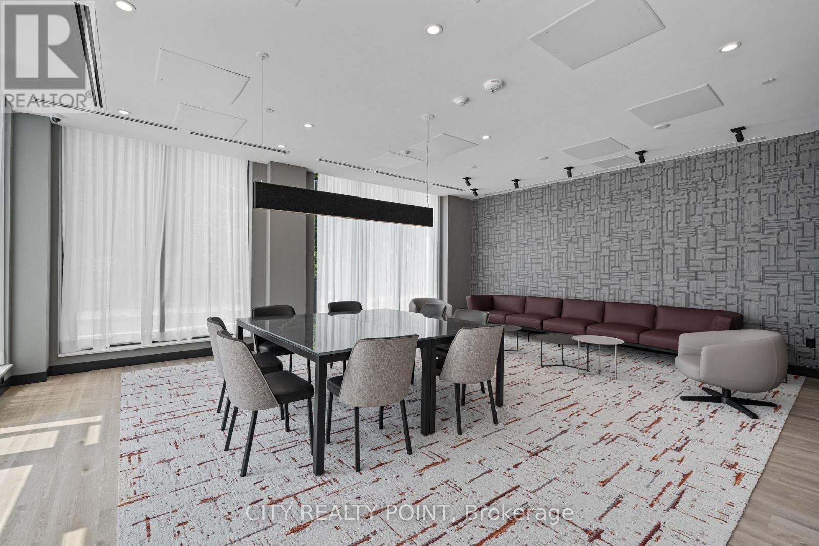 A modern dining room with a glass table and chairs.