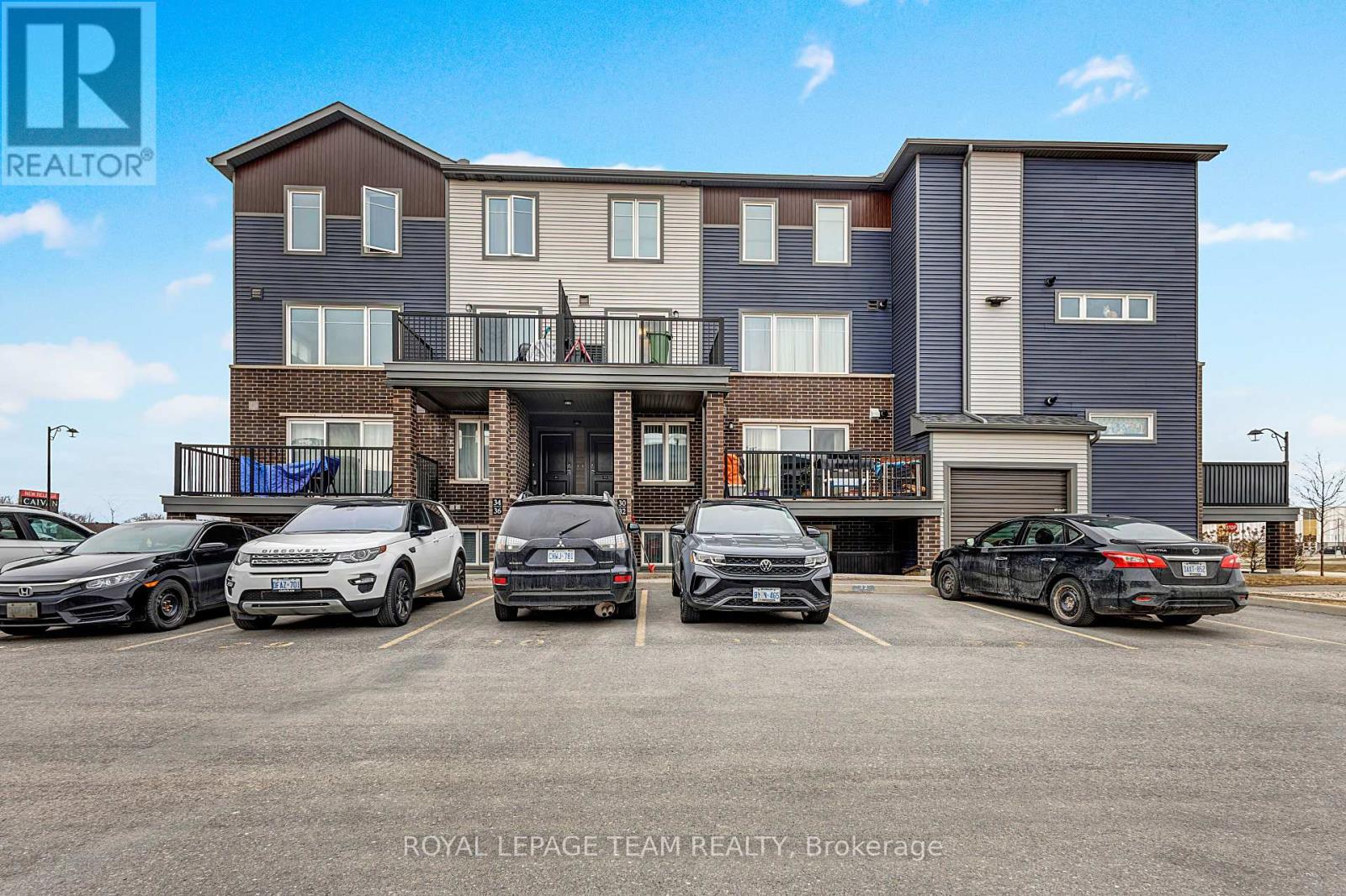 A parking lot with cars and a building in the background.