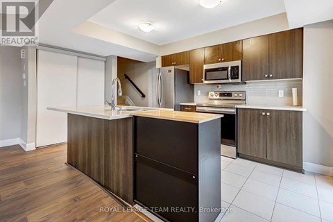 A modern kitchen with wooden cabinets and a central island.