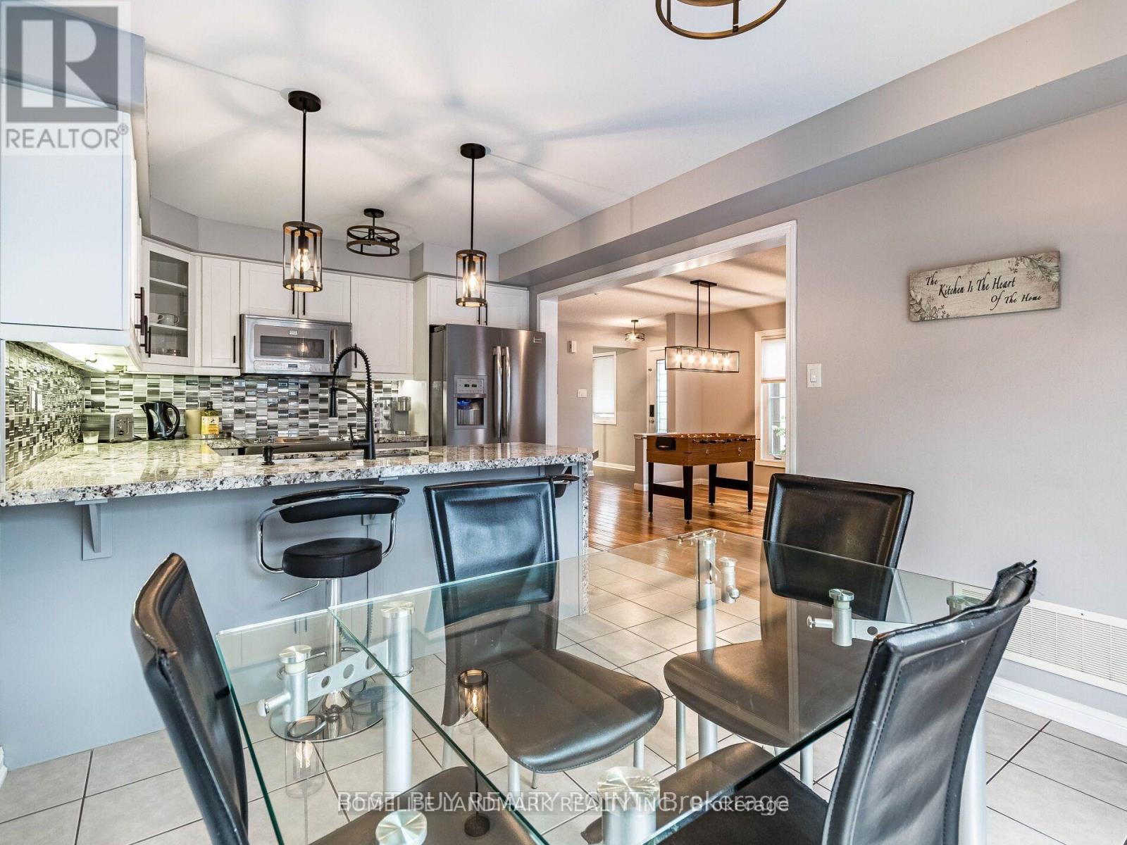 A modern kitchen with a glass table and chairs.