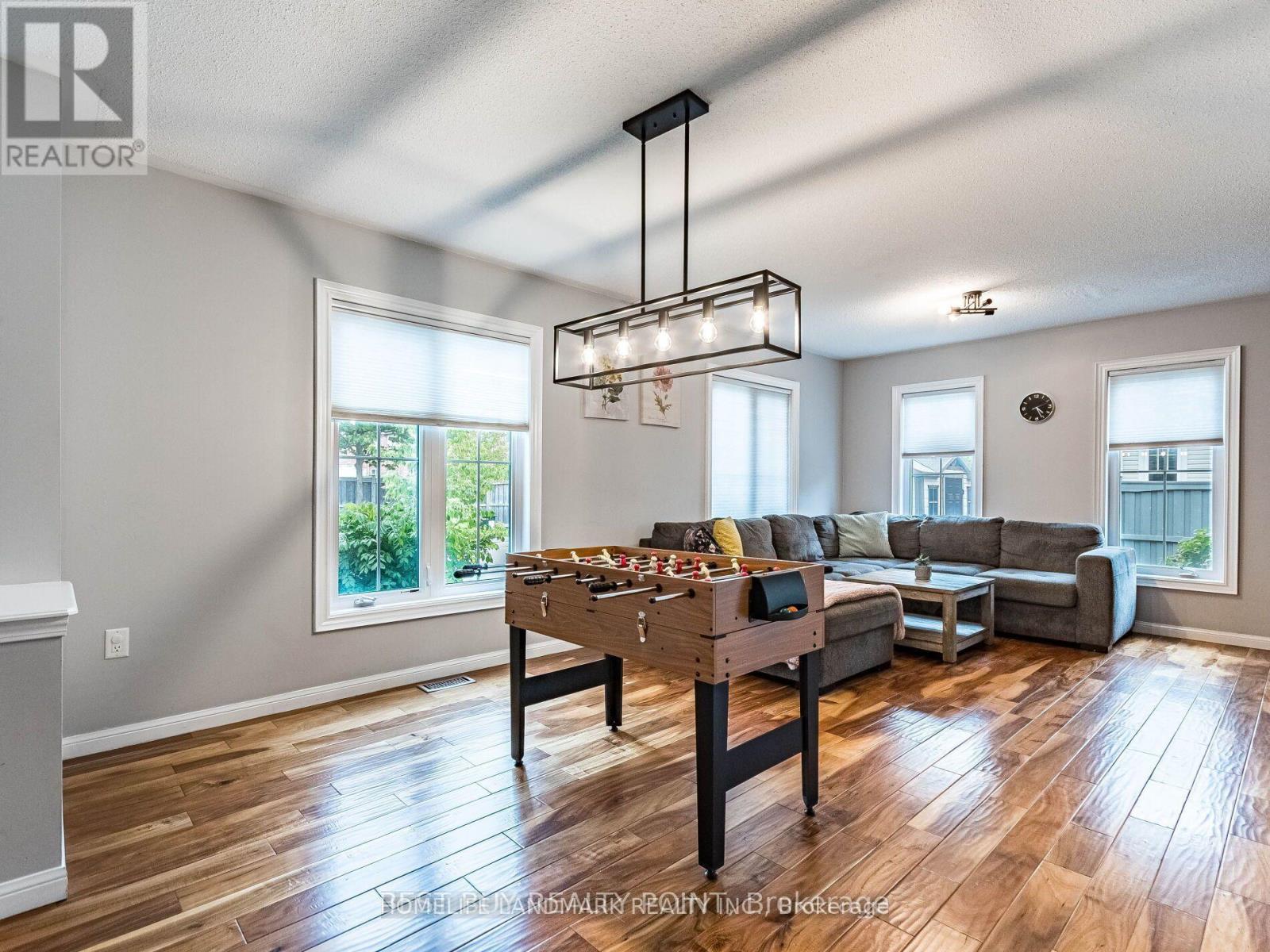 A well-lit living room with a dining table and a couch.