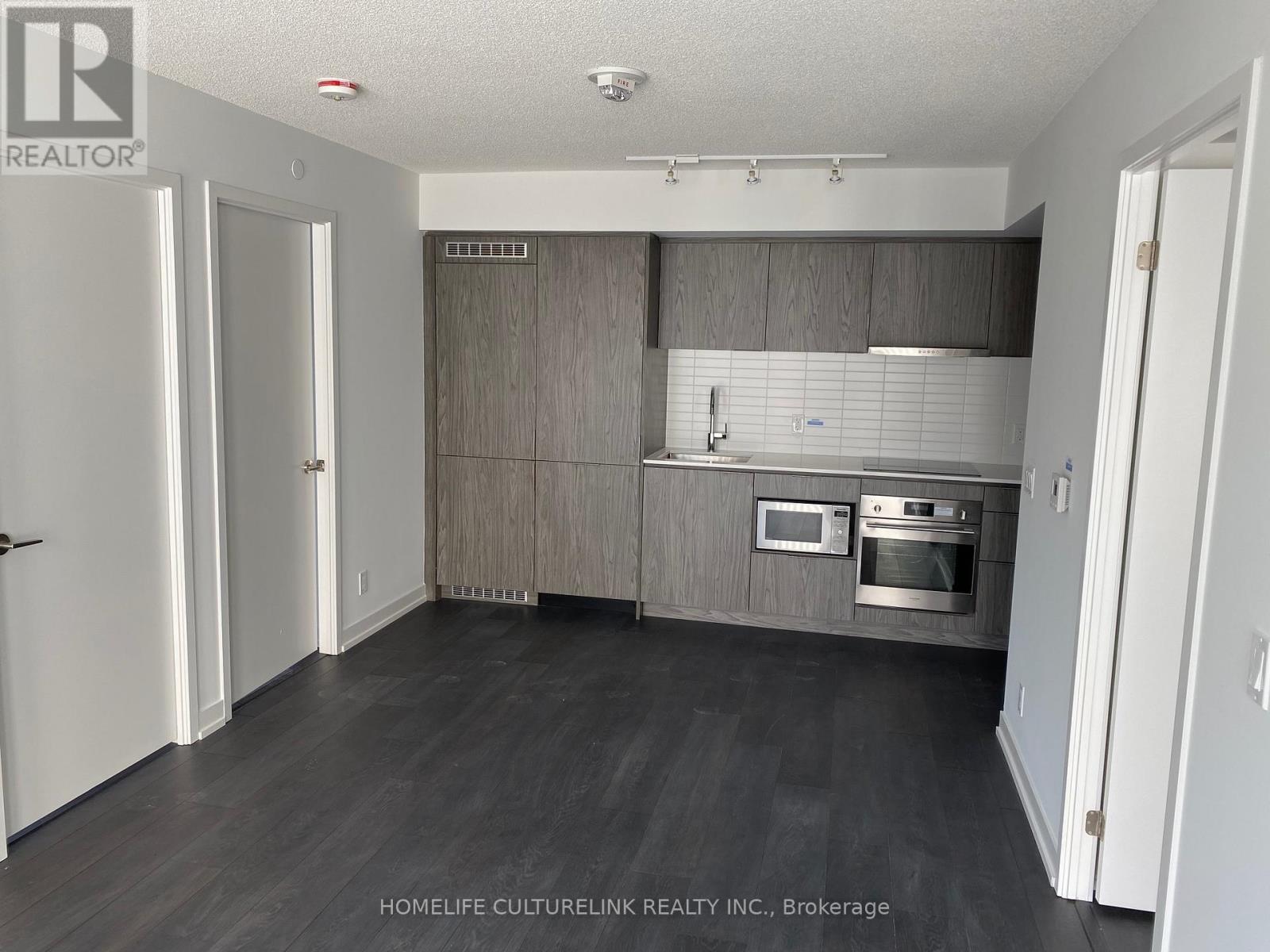 A kitchen with a stove top oven and microwave.