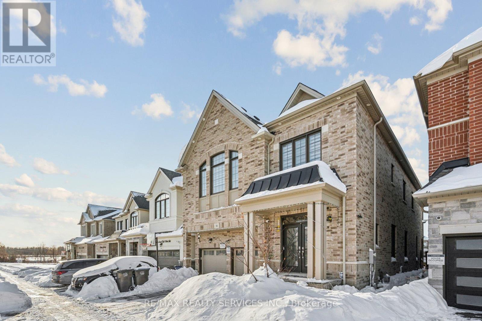 A row of houses with a RE/MAX Realty logo.