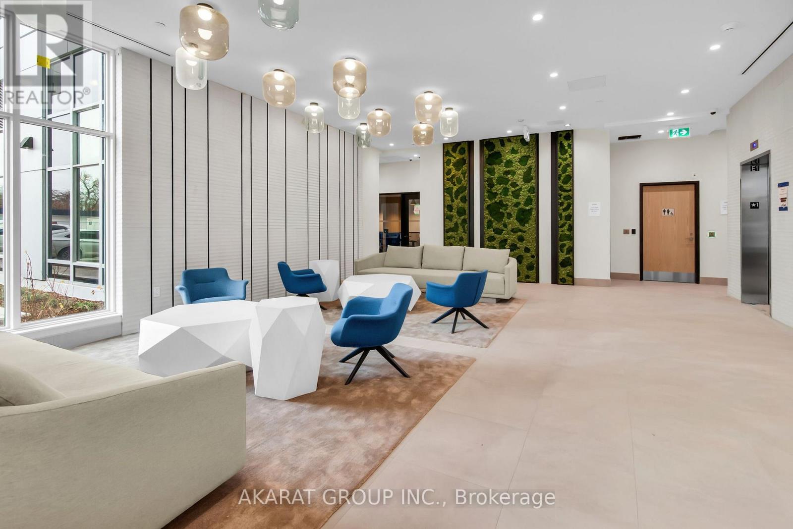A modern office space with blue chairs and white furniture.