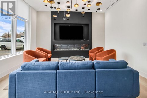A living room with a blue sofa and orange chairs.