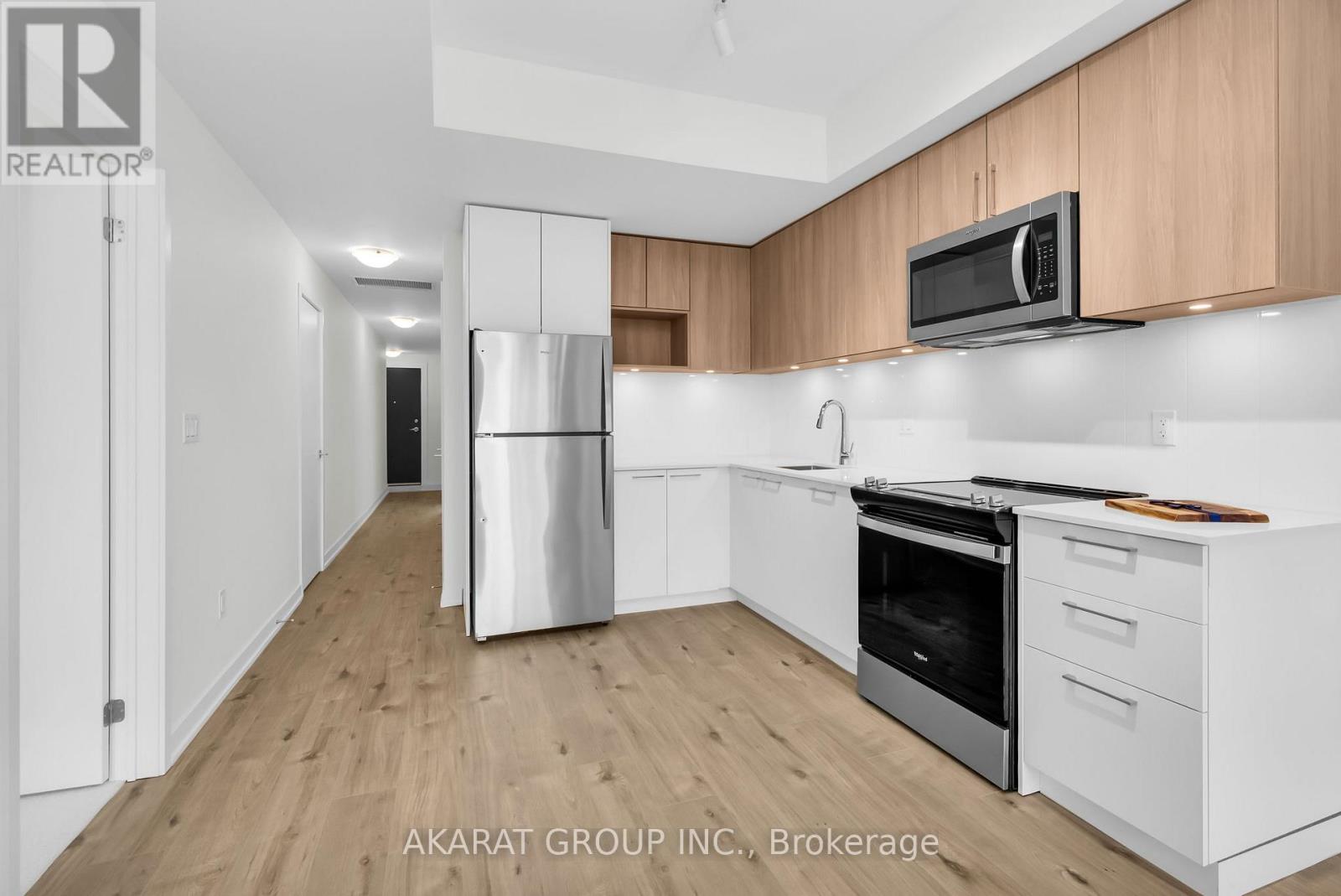 A kitchen with wooden cabinets and stainless steel appliances.