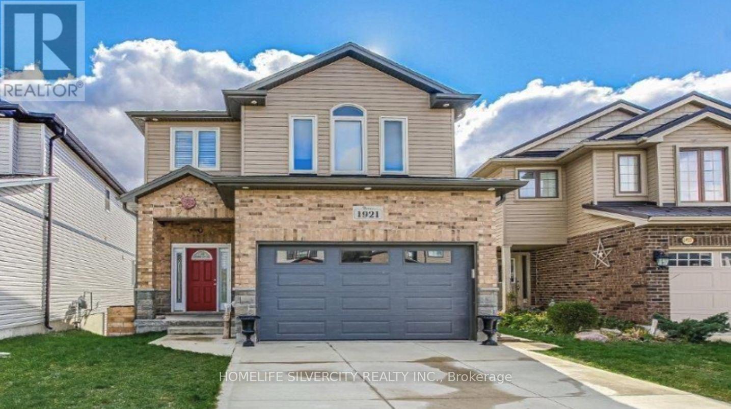 A two-story house with a garage is for sale.