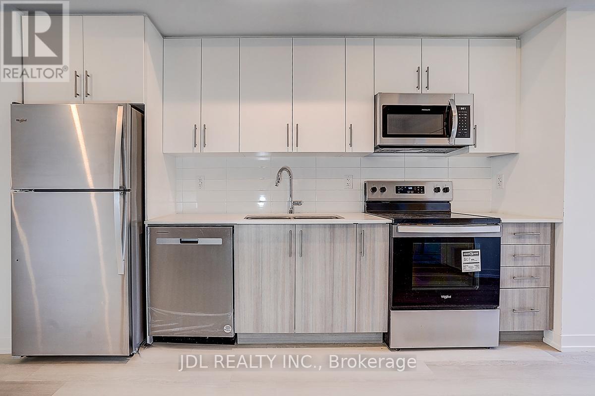 A kitchen with white cabinets and stainless steel appliances.