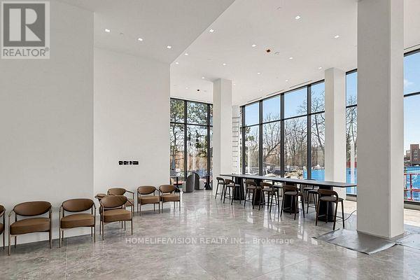 A conference room with a long table and chairs is shown.
