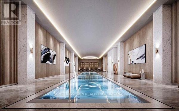 A long, narrow indoor swimming pool with a lighted floor.