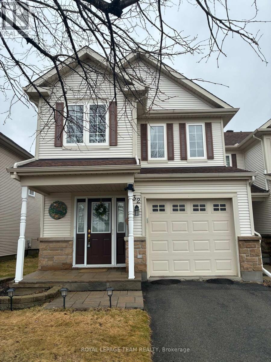 A two-story house with a garage and a front door with a wreath on it.