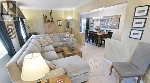 A living room with a grey couch and a wooden coffee table.
