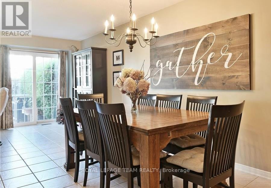 A dining room with a wooden table and chairs.