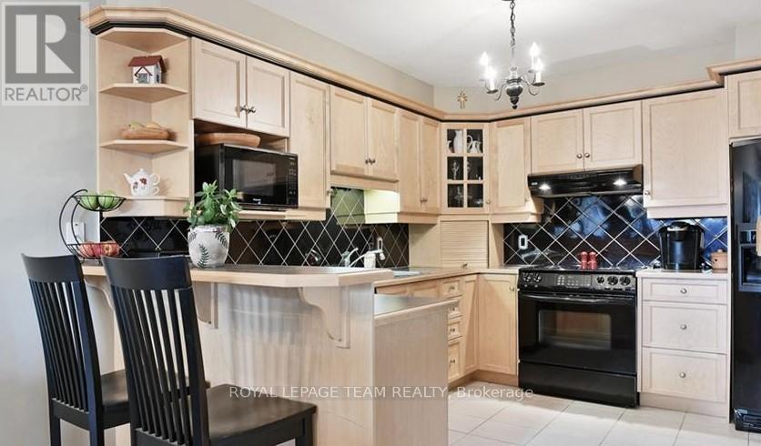 A kitchen with wooden cabinets and black appliances.