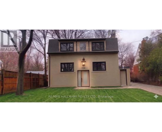 A house with a brown fence and a green lawn in front.